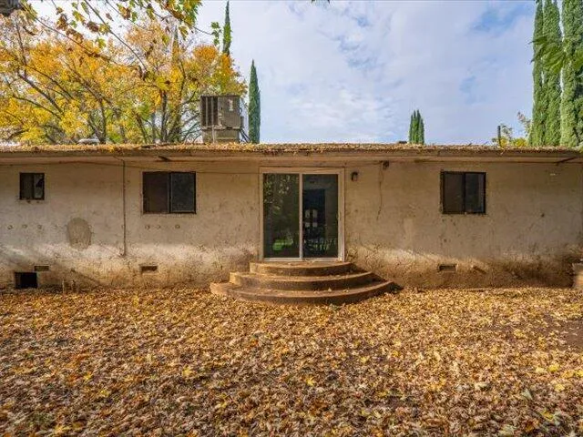 a backyard of a house with table and chairs