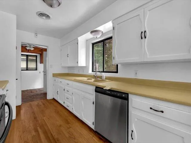 a kitchen with granite countertop a sink and cabinets