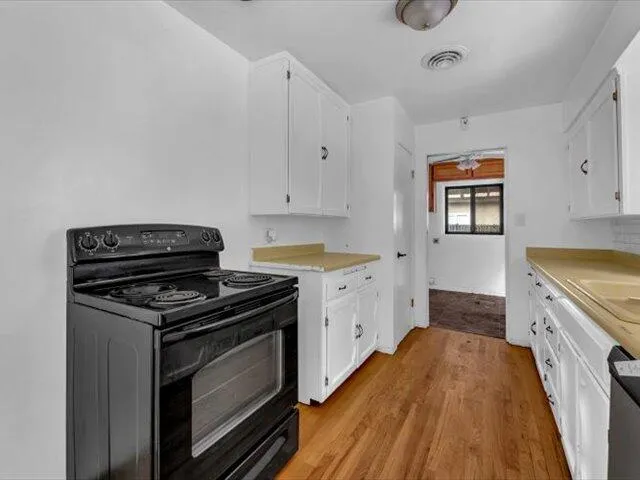 a kitchen with a stove and a sink