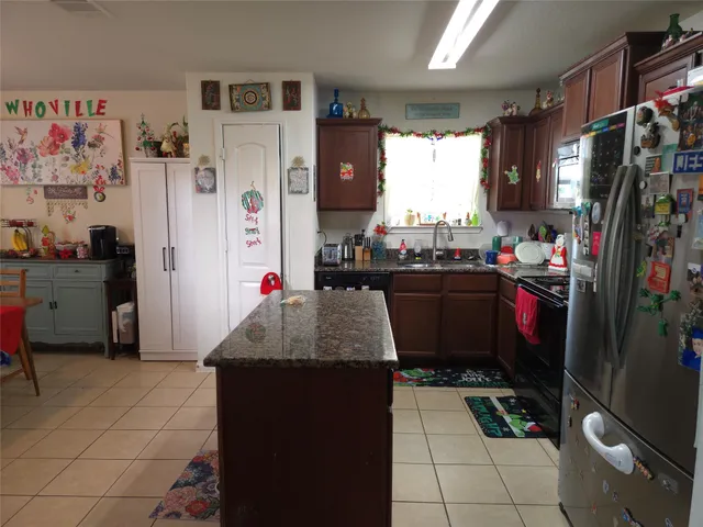 a bedroom with a bed ceiling fan and a window