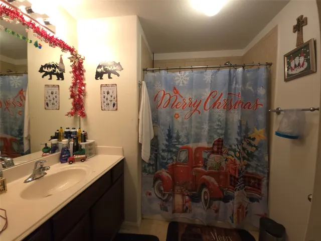 a bathroom with a toilet and a shower curtain