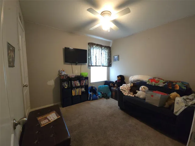 a bathroom with a refrigerator and a window