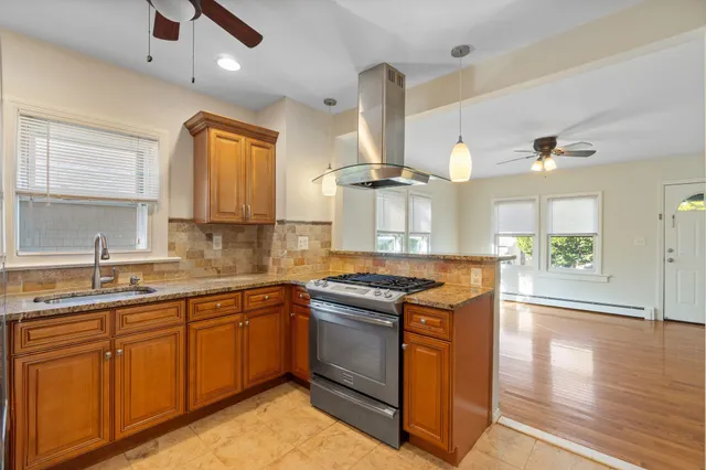 a kitchen with a sink stove and wooden cabinets