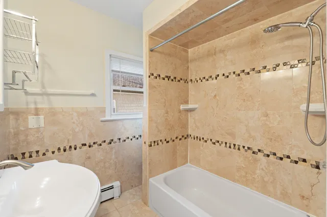 a bathroom with a bathtub and shower