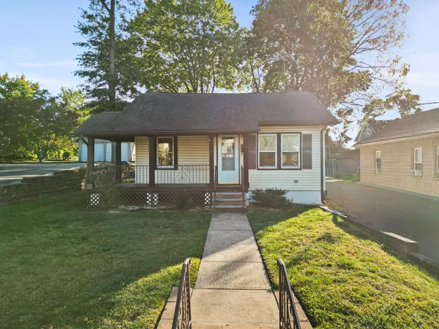 a view of a house with yard and sitting area