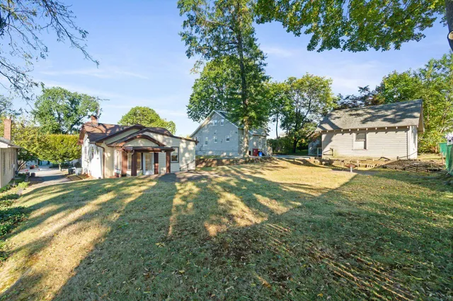 a front view of house with a garden and patio