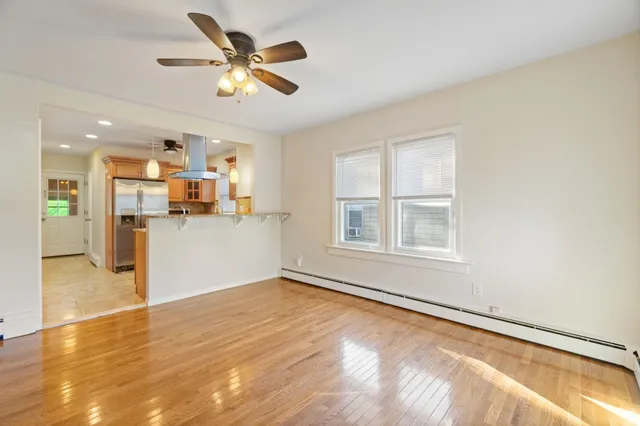 a view of a kitchen with wooden floor and a window