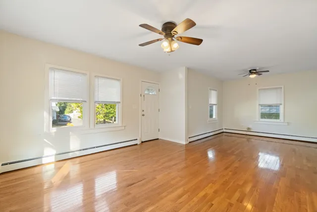 wooden floor in an empty room with a window