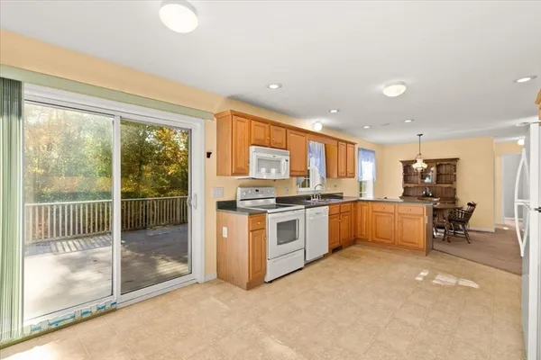 a kitchen with stainless steel appliances granite countertop a stove and a refrigerator