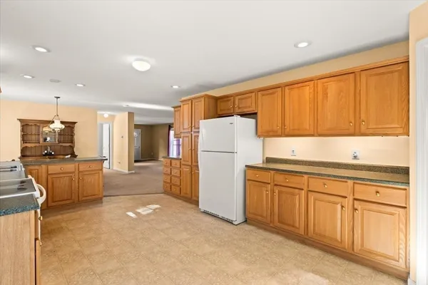 a kitchen with refrigerator cabinets and a sink