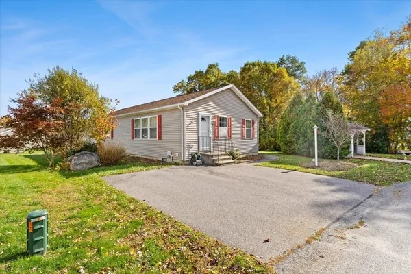 a view of backyard of house with green space