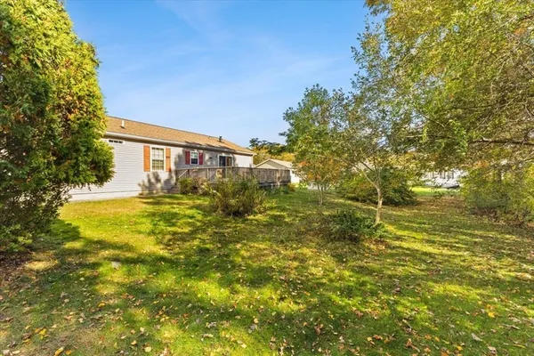 a backyard of a house with large trees