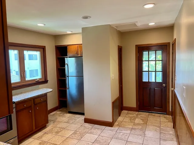 a kitchen with stainless steel appliances granite countertop a refrigerator and a sink