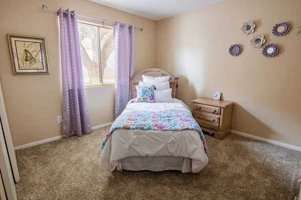 a bedroom with a bed and a window