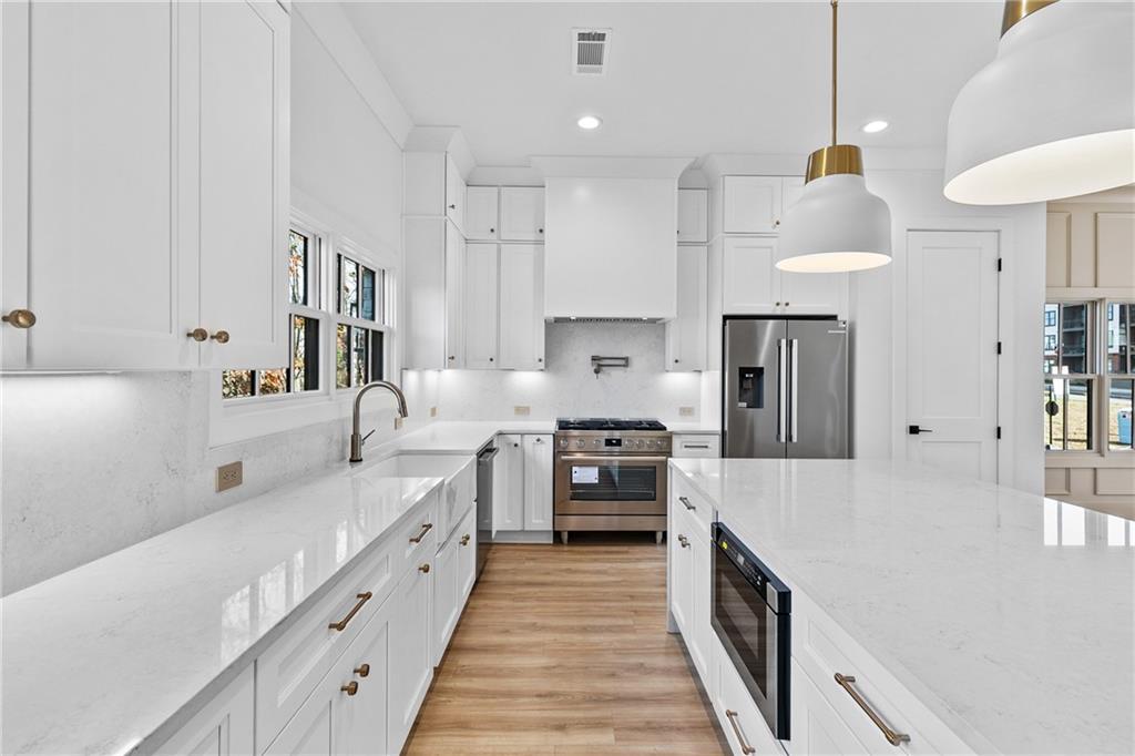 339 Sugarview Road Sugar Hill, GA 30518 - Photo 12 of 53 a large kitchen with stainless steel appliances granite countertop a lot of counter space and a refrigerator