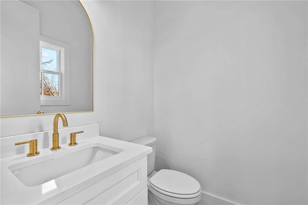 339 Sugarview Road Sugar Hill, GA 30518 - Photo 18 of 53 a bathroom with a toilet a sink and mirror