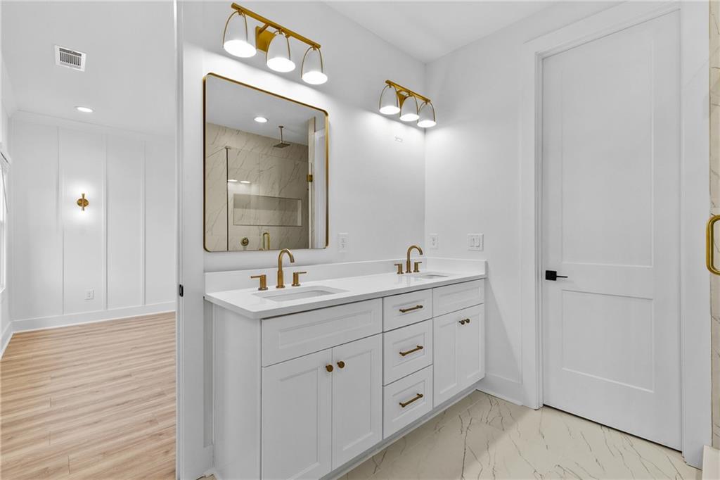 339 Sugarview Road Sugar Hill, GA 30518 - Photo 28 of 53 a bathroom with a double vanity sink and a mirror
