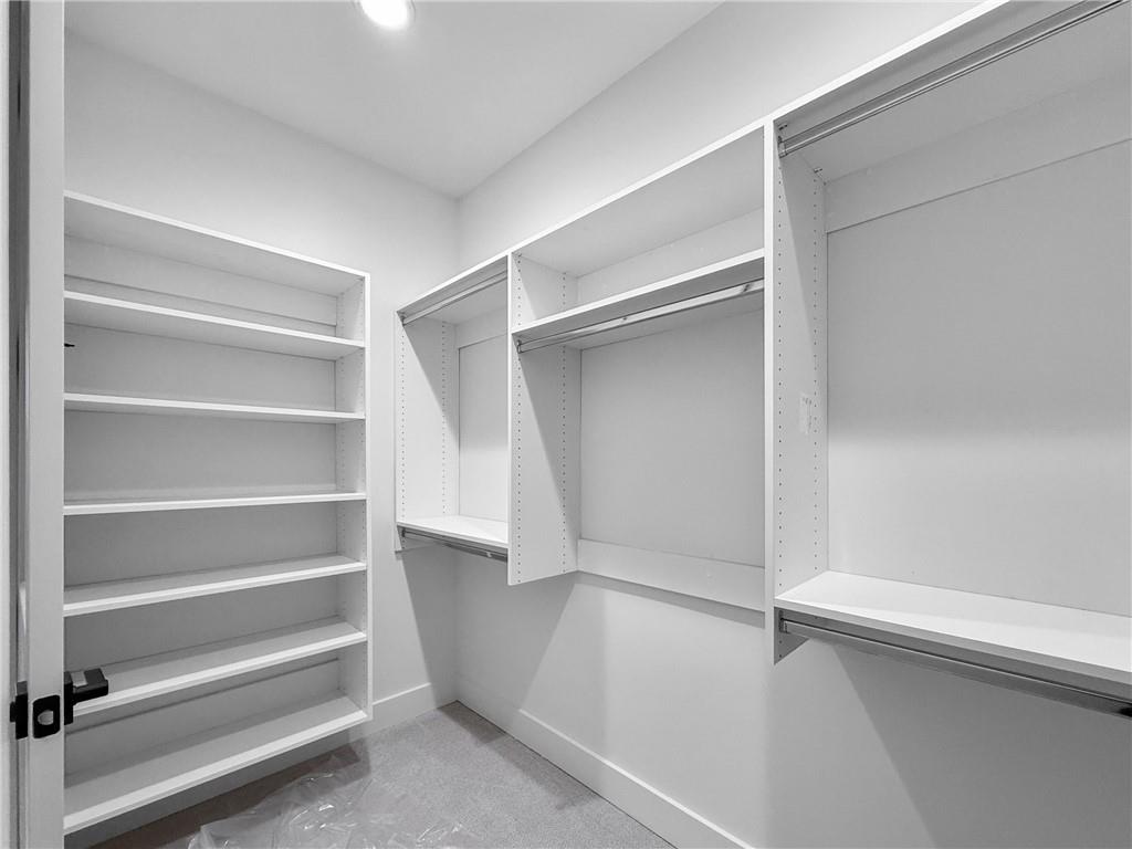 339 Sugarview Road Sugar Hill, GA 30518 - Photo 30 of 53 a view of walk in closet with empty racks