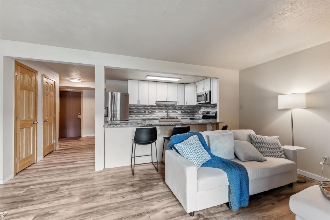 535 Straight Creek Drive, Unit 104 Dillon, CO 80435 - Photo 11 of 30 a living room with furniture and kitchen view