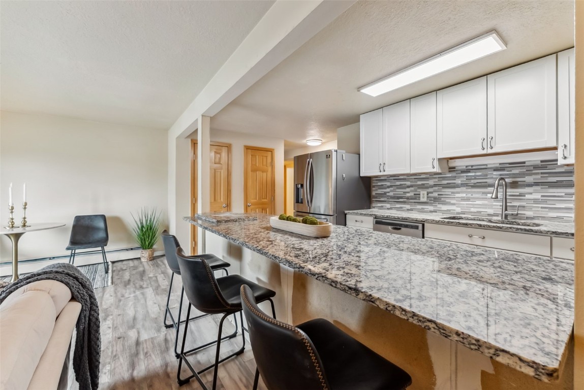 535 Straight Creek Drive, Unit 104 Dillon, CO 80435 - Photo 15 of 30 a kitchen with counter top space cabinets and stainless steel appliances