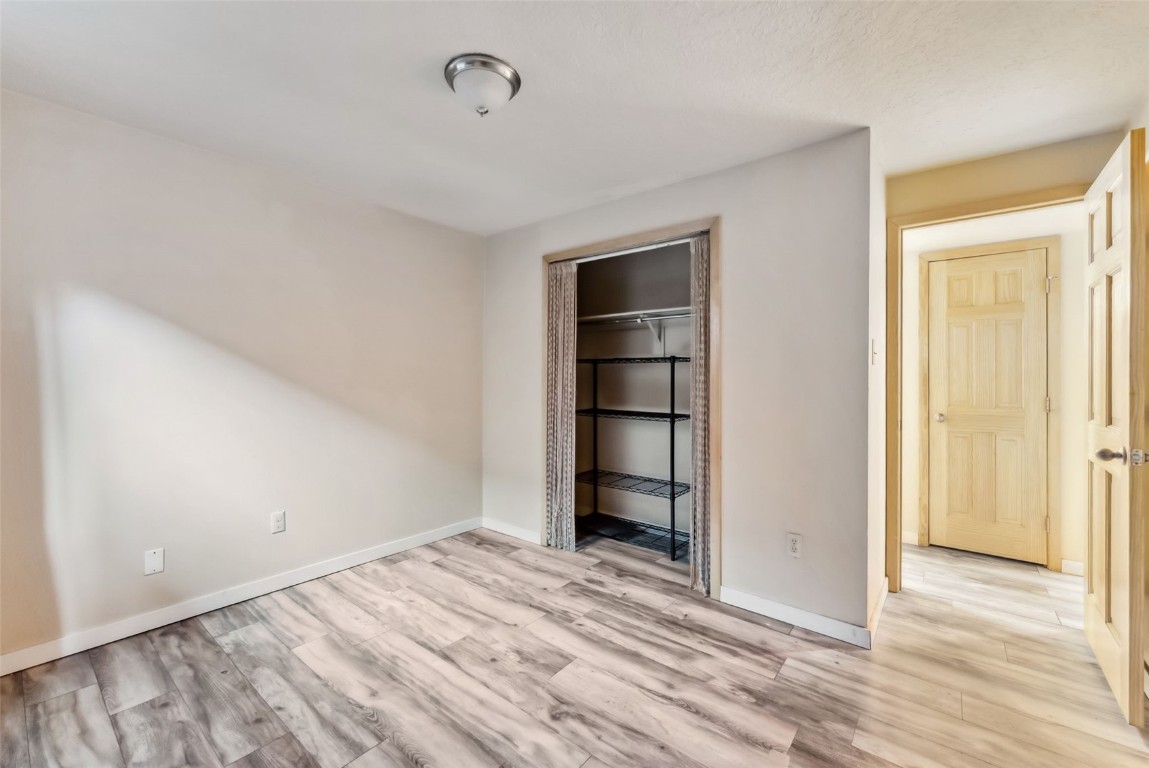 535 Straight Creek Drive, Unit 104 Dillon, CO 80435 - Photo 21 of 30 a view of empty room with wooden floor and cabinet