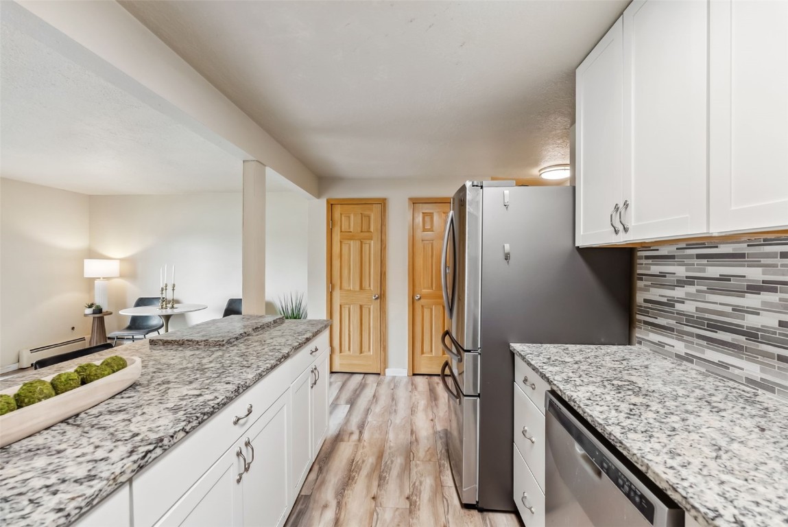 535 Straight Creek Drive, Unit 104 Dillon, CO 80435 - Photo 3 of 30 a kitchen with granite countertop a sink stove and refrigerator
