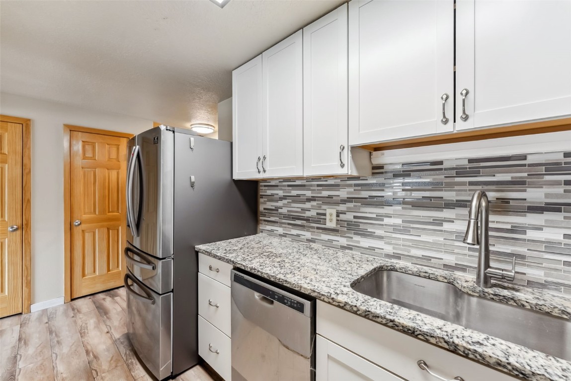 535 Straight Creek Drive, Unit 104 Dillon, CO 80435 - Photo 7 of 30 a kitchen with stainless steel appliances granite countertop a refrigerator and a sink