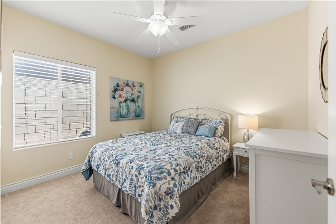 3315 Rainbow Mine Road Kingman, AZ 86401 - Photo 35 of 54 This room features neutral-toned carpet, a large window with blinds, and a ceiling fan