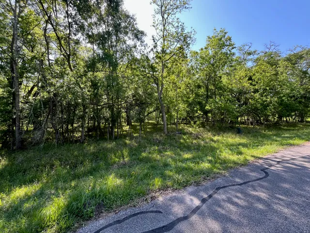 a backyard of a house with outdoor seating and trees