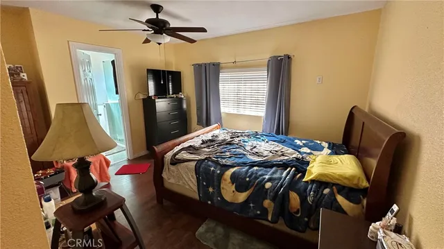 a bedroom with a bed and flat screen tv