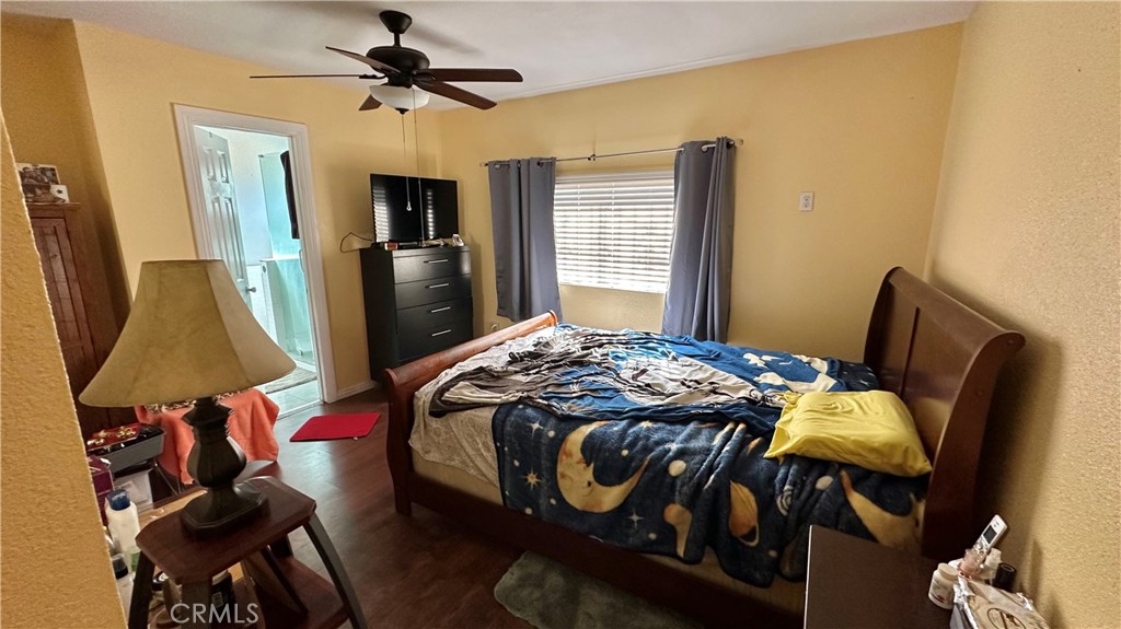 407 South Vancouver Avenue Los Angeles, CA 90022 - Photo 15 of 24 a bedroom with a bed and flat screen tv