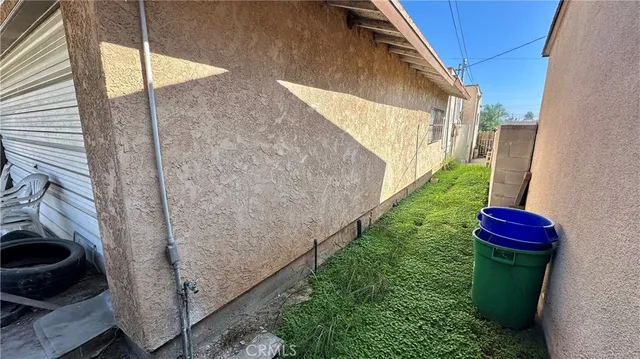 a view of a backyard with wooden fence
