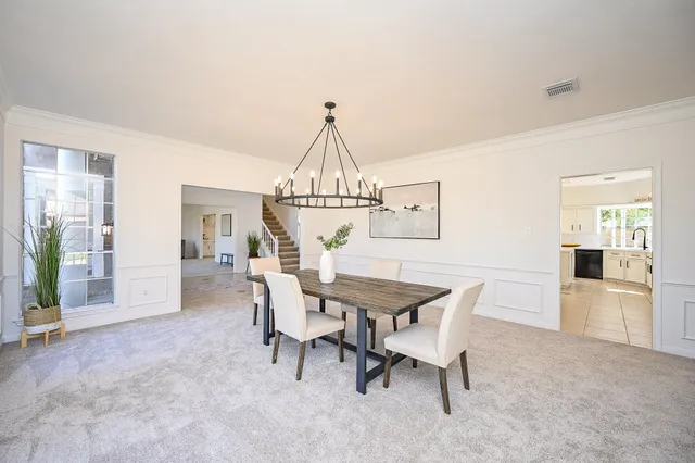 a view of a dining room with furniture and window