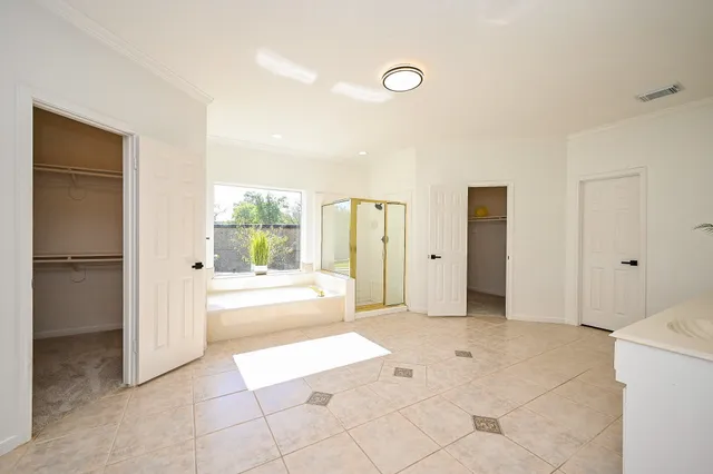 a large bathroom with a large mirror vanity and shower