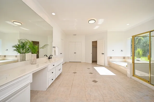 a spacious bedroom with a bed and a ceiling fan