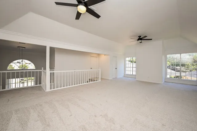 a view of a livingroom with a ceiling fan and window