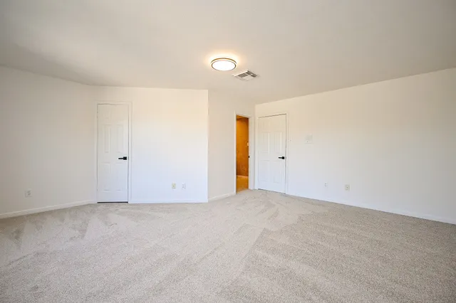 a bathroom with double vanity sink a mirror a window and a bathtub