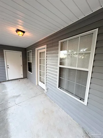 a view of a yard with wooden fence