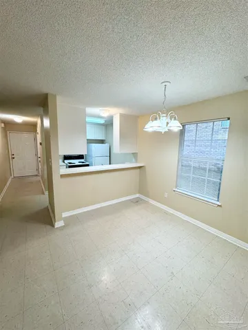 a kitchen with a stove and a refrigerator