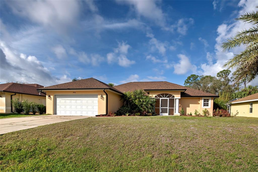 4966 Sunnyvale Road North Port, FL 34288 - Photo 1 of 1 a front view of a house with a yard