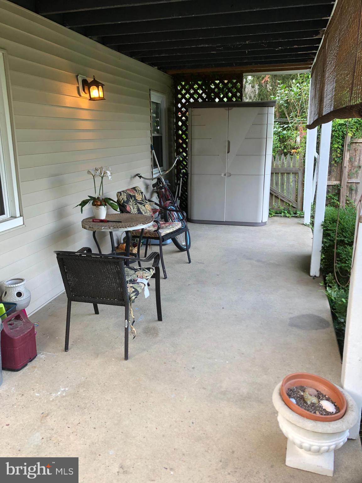 52 Hanover Street Pemberton, NJ 08068 - Photo 37 of 40 a view of a patio with table and chairs and potted plants