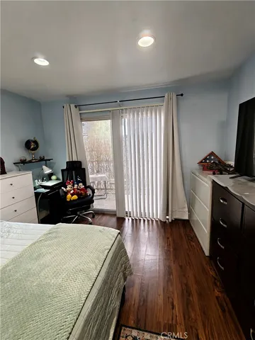 a bed room with a bed table and a window