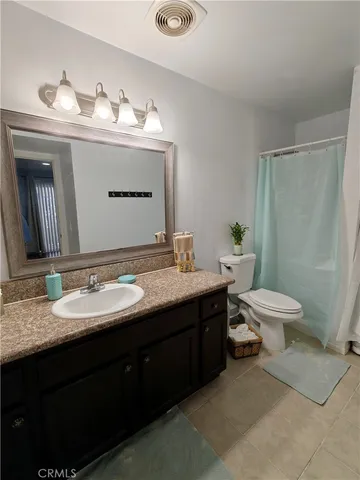 a bathroom with a double vanity sink toilet and a mirror