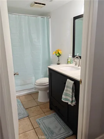 a bathroom with a sink toilet and mirror