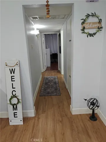 a hallway view with staircase