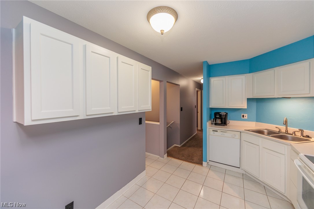 6472 State Road, Unit J19 Parma, OH 44134 - Photo 13 of 33 Kitchen with white appliances, light tile floors, sink, and white cabinetry