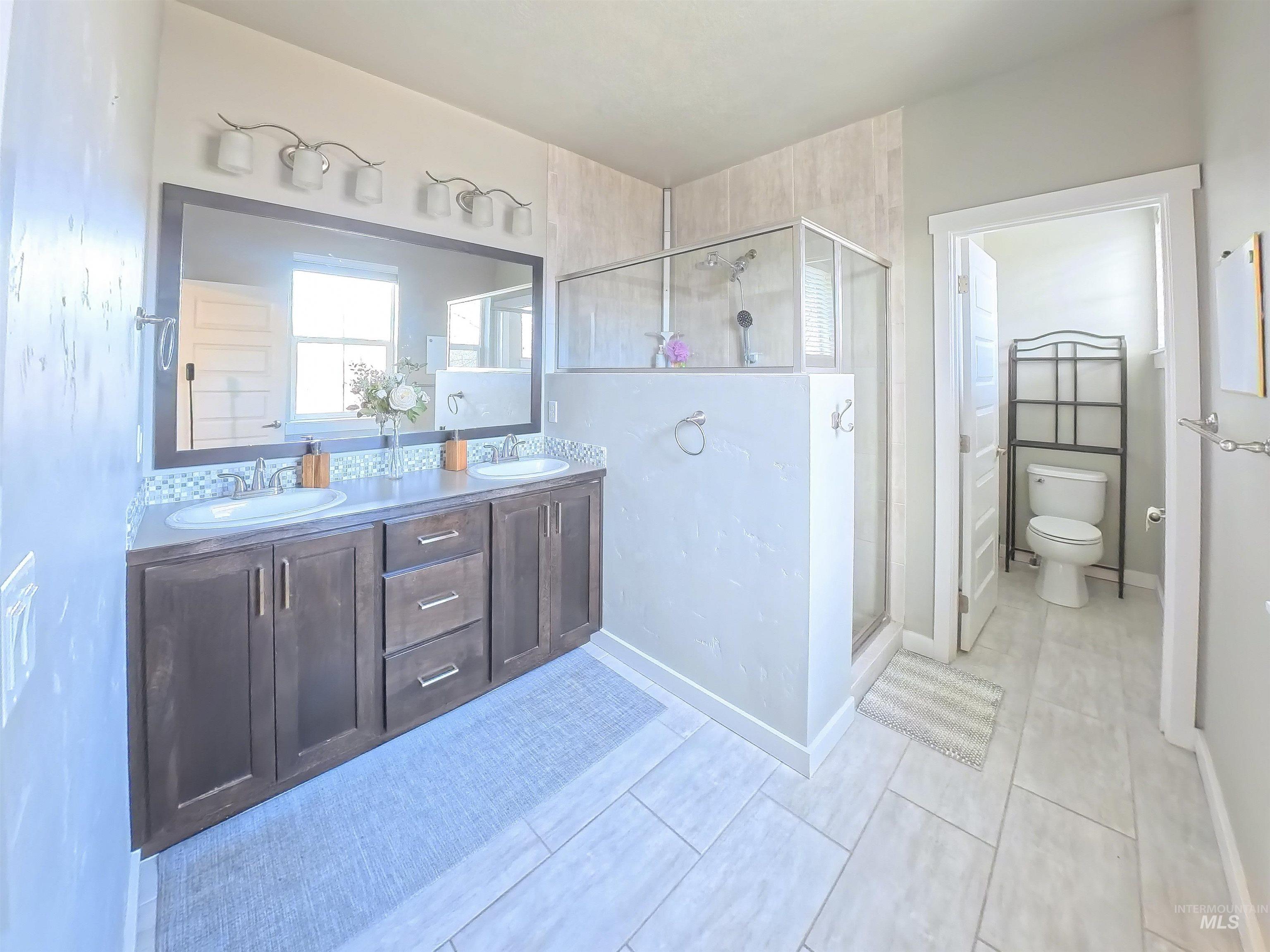 347 South Truss Lane Meridian, ID 83642 - Photo 14 of 24 Bathroom featuring double vanity and a shower stall