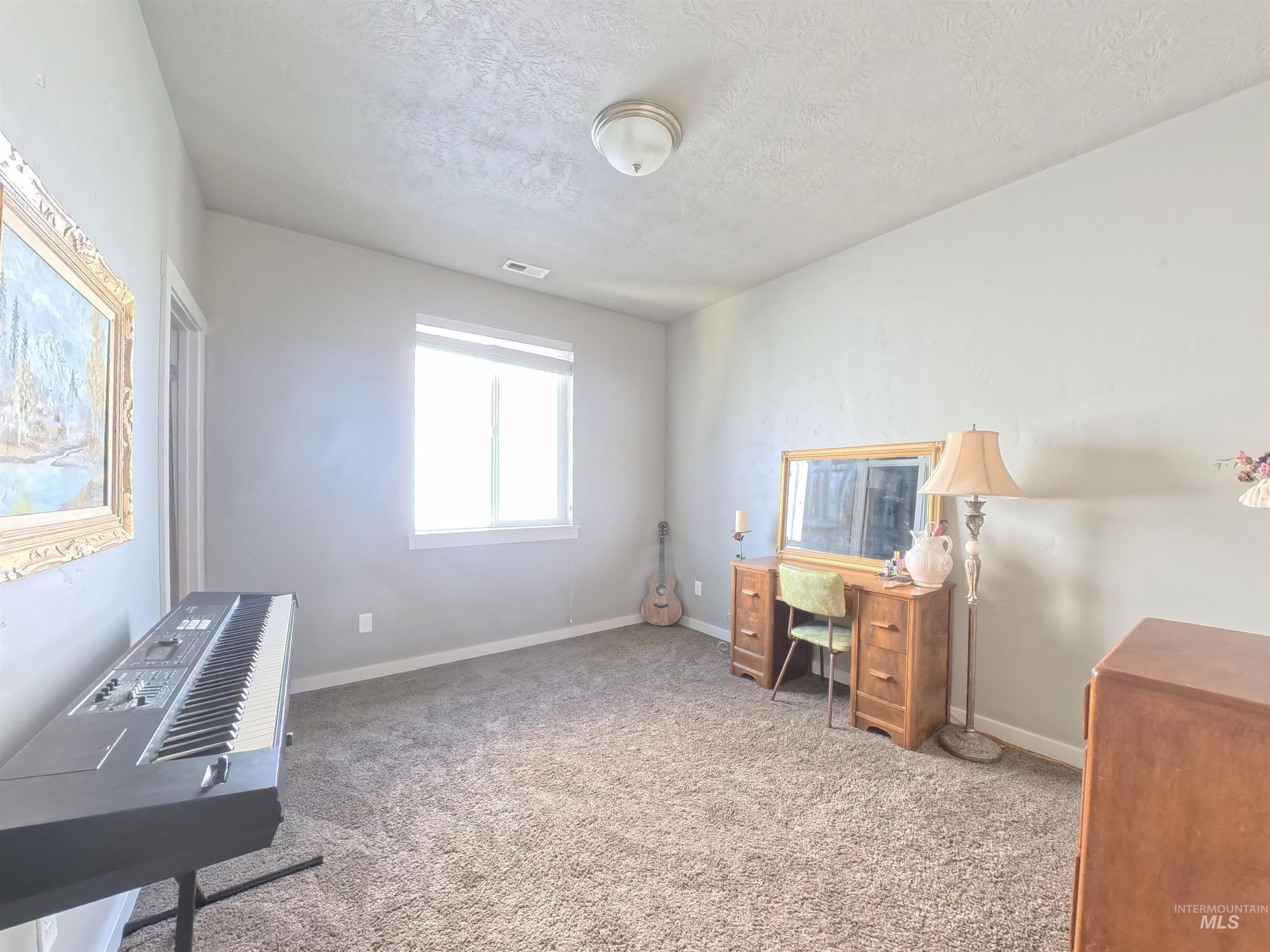 347 South Truss Lane Meridian, ID 83642 - Photo 18 of 24 Unfurnished office featuring carpet flooring and a textured ceiling