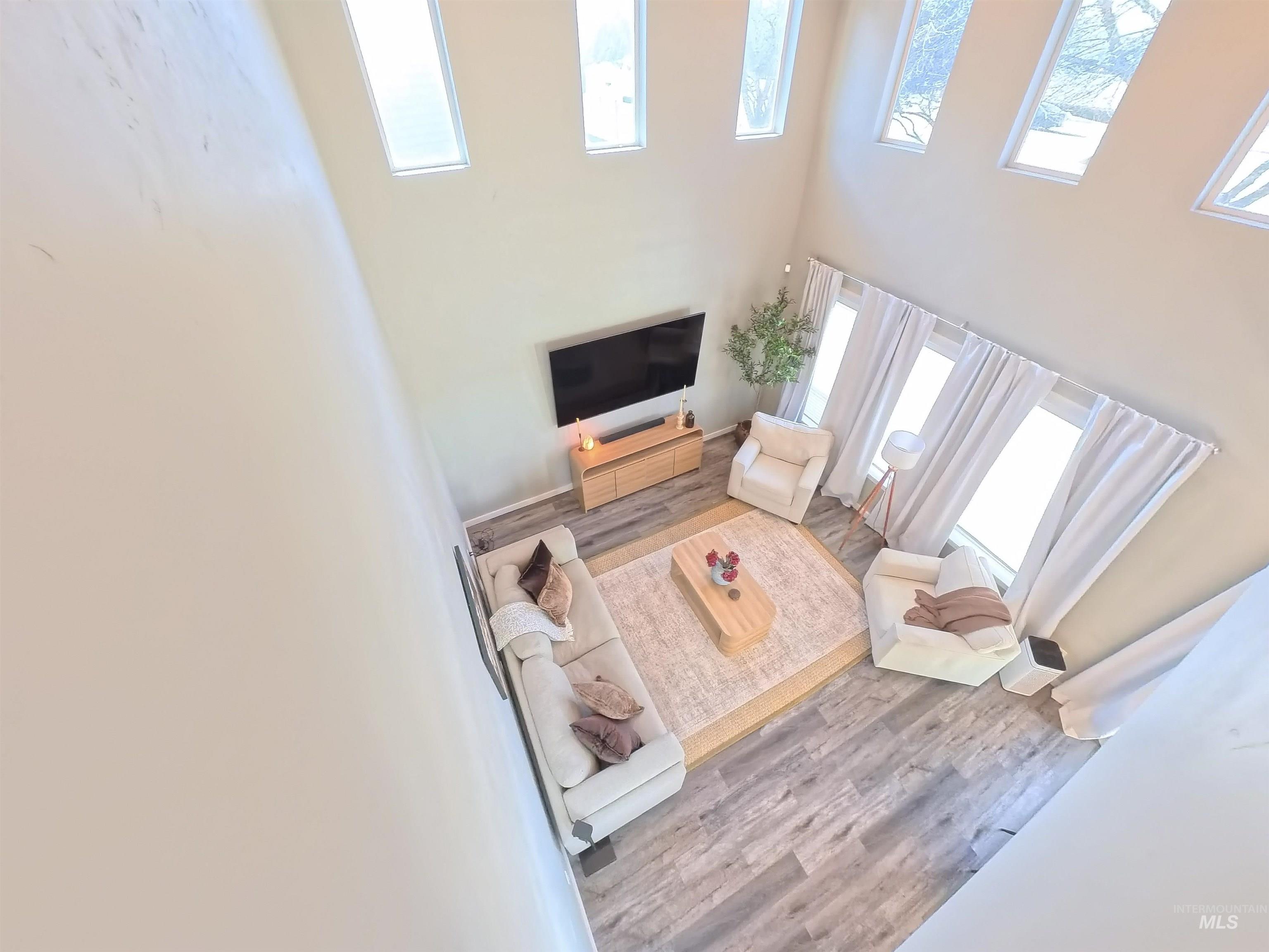 347 South Truss Lane Meridian, ID 83642 - Photo 21 of 24 Living area with wood finished floors and a high ceiling