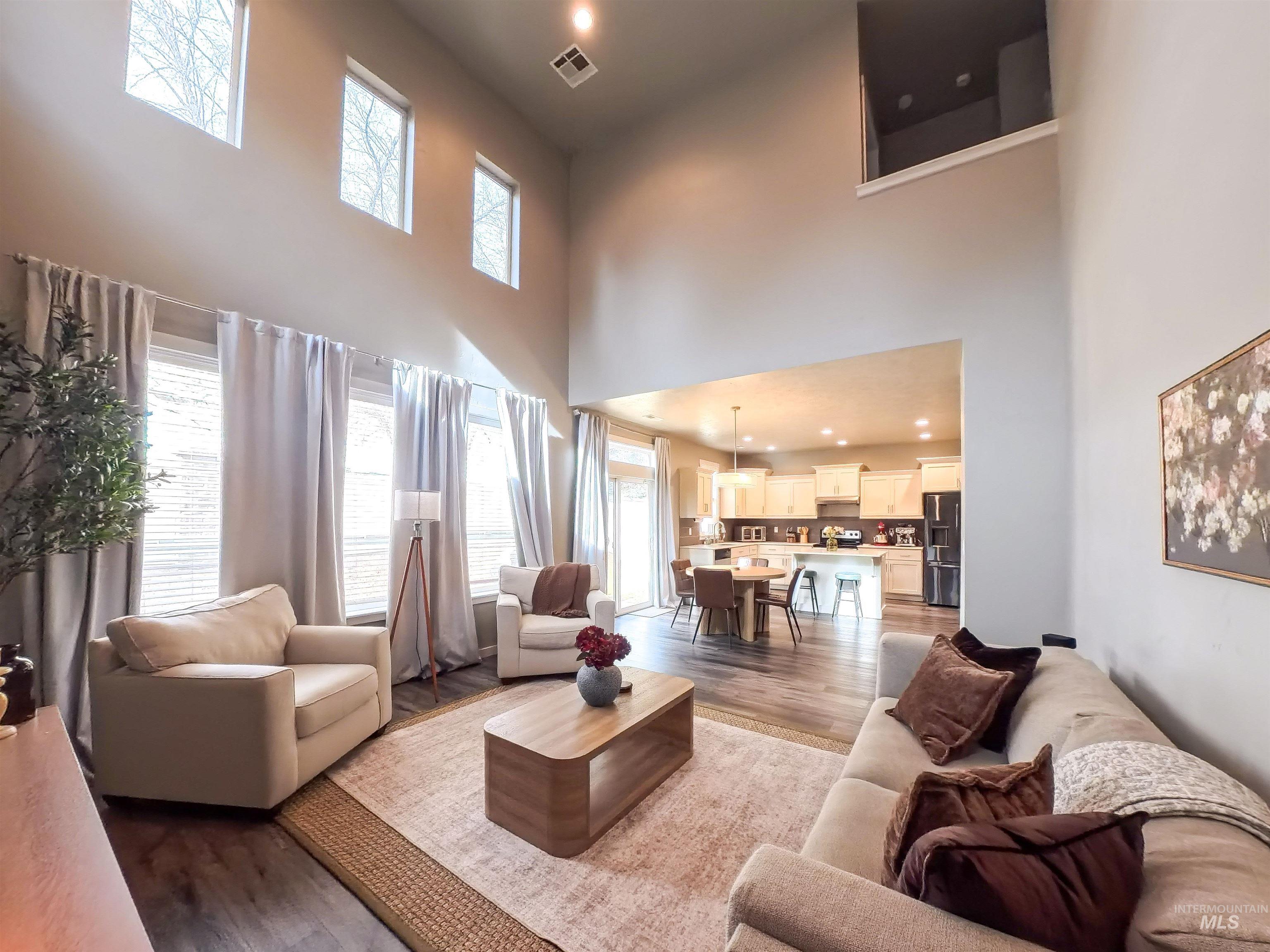 347 South Truss Lane Meridian, ID 83642 - Photo 6 of 24 Living room with recessed lighting, light wood finished floors, and a high ceiling